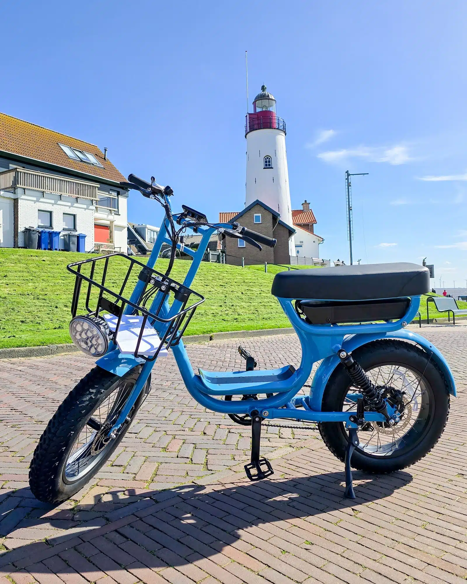 electric green bike bicycle on a beautiful bright day Netherlands Urk, blue electric fatbike